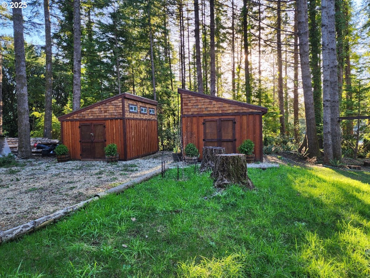 Orchard Road, Unit 3 Port Orford, OR 97465 - Photo 3 of 32 a view of a chair and table in backyard of the house