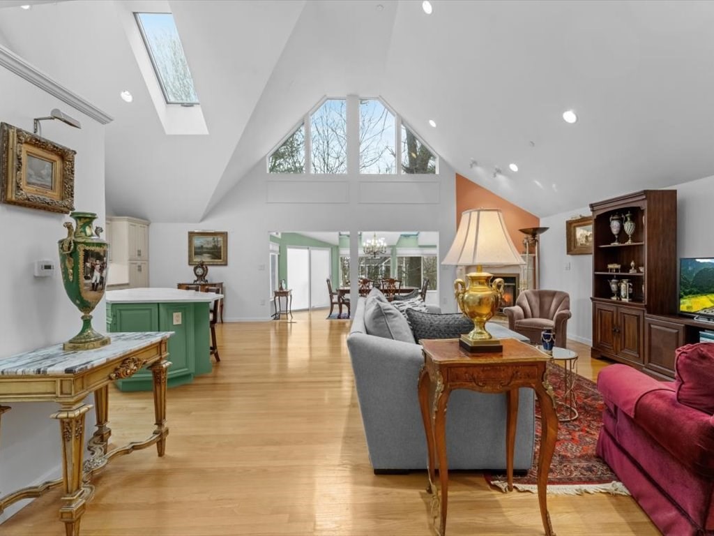 29 Deer Path, Unit 29 Hudson, MA 01749 - Photo 12 of 42 a living room with furniture a chandelier and a flat screen tv