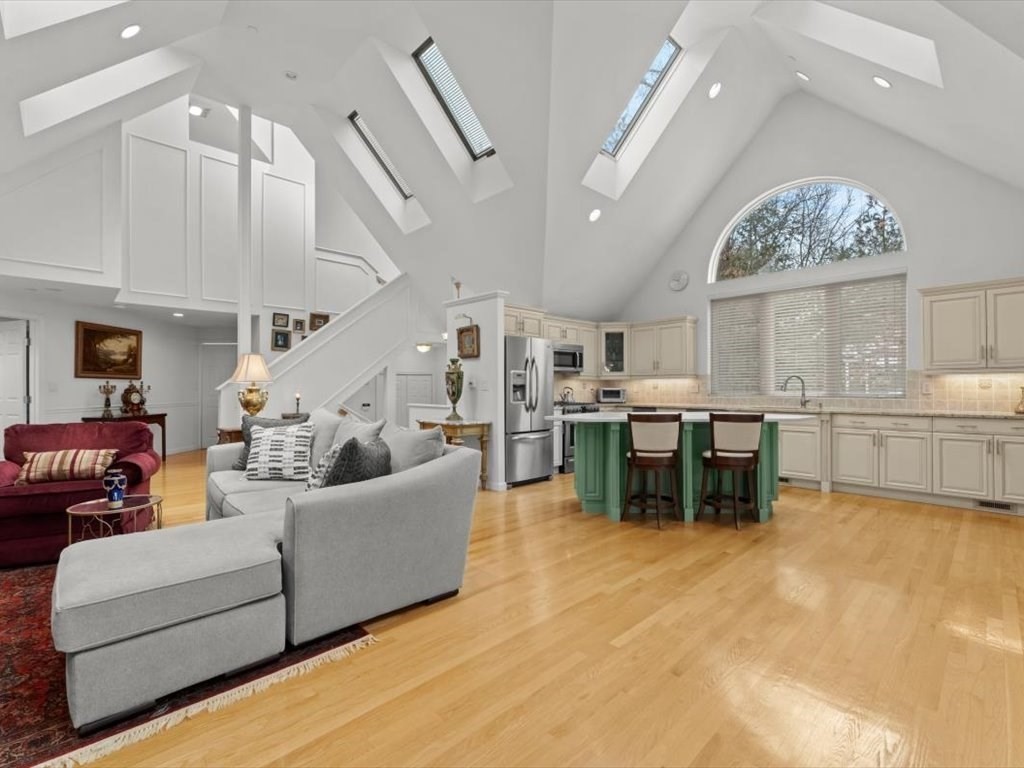 29 Deer Path, Unit 29 Hudson, MA 01749 - Photo 13 of 42 a living room with furniture and kitchen view