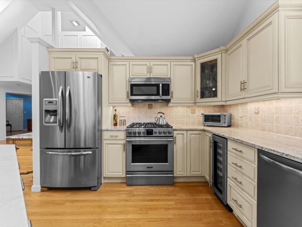 29 Deer Path, Unit 29 Hudson, MA 01749 - Photo 16 of 42 a kitchen with stainless steel appliances granite countertop a stove a refrigerator and a sink
