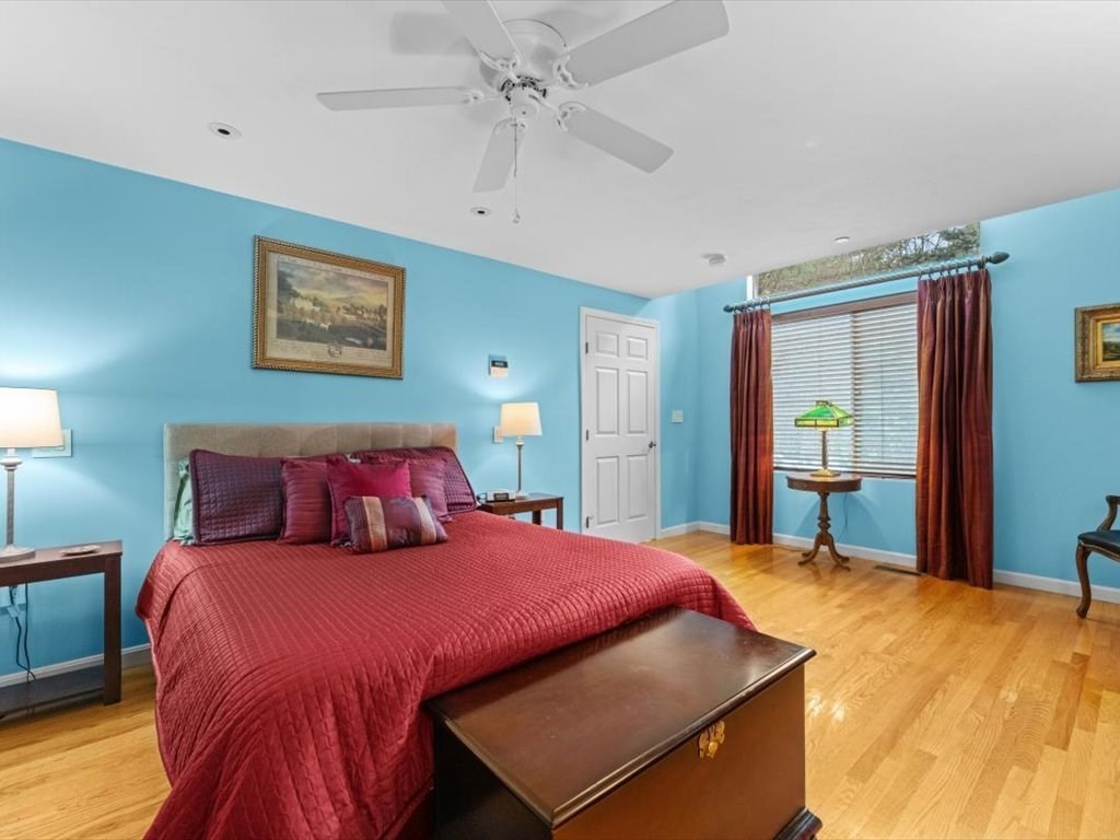 29 Deer Path, Unit 29 Hudson, MA 01749 - Photo 23 of 42 a bedroom with a bed and a large mirror