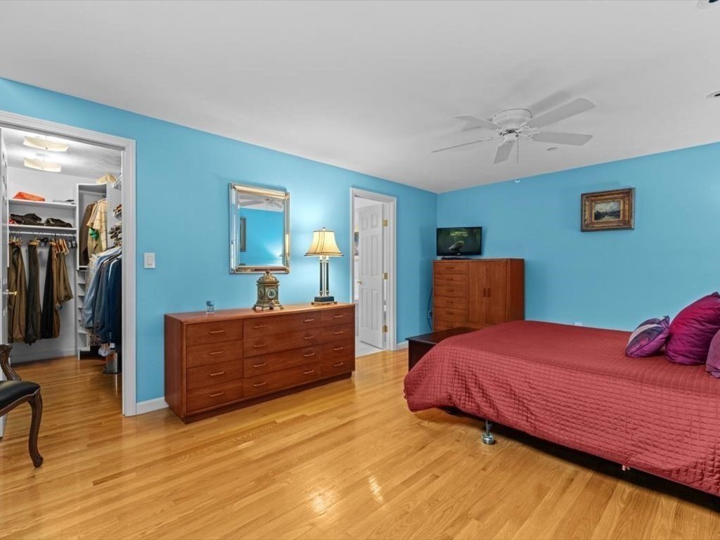 29 Deer Path, Unit 29 Hudson, MA 01749 - Photo 24 of 42 a bedroom with a bed and a mirror