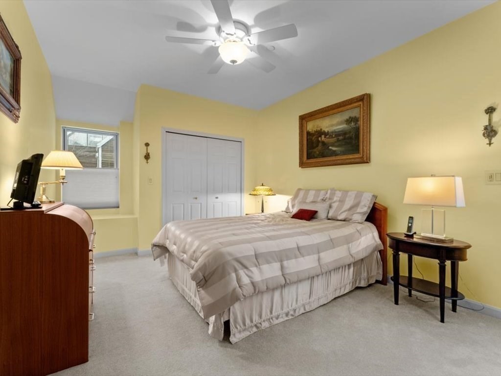 29 Deer Path, Unit 29 Hudson, MA 01749 - Photo 27 of 42 a bedroom with a bed and a lamp with window