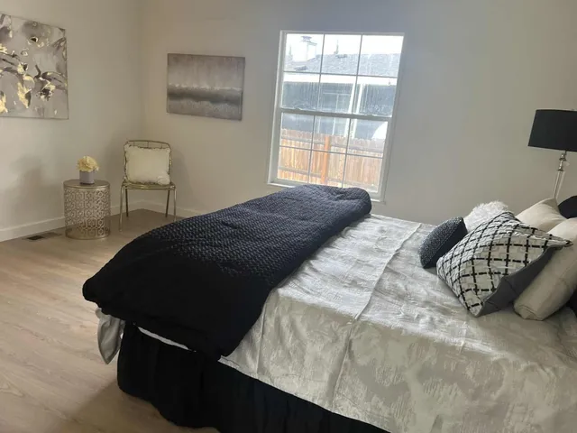 a bedroom with a bed and a window