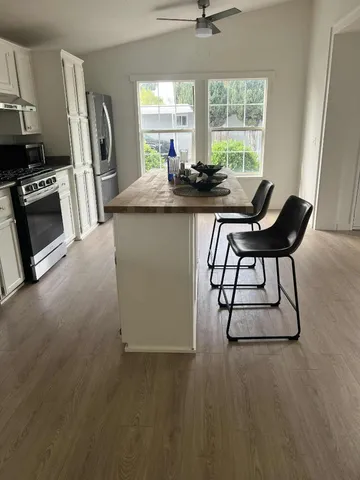 a dining room with furniture and a window