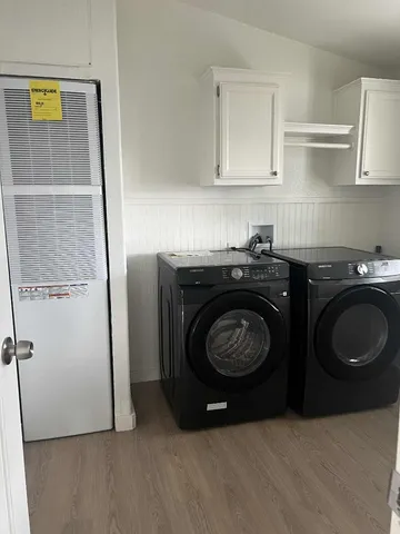 a utility room with sink dryer and washer