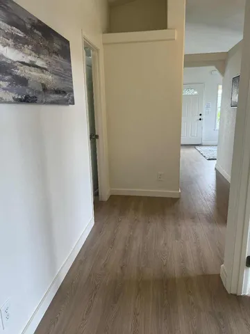 a view of a room with wooden floor