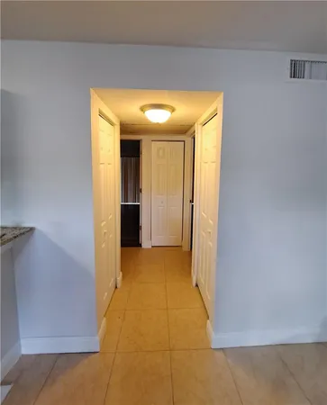 a view of a hallway with a bathroom