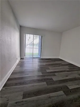 a view of wooden floor and windows in a room