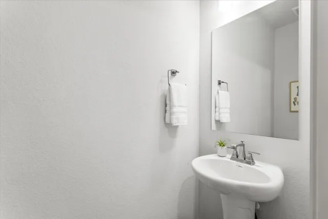 a bathroom with a sink a mirror and a toilet