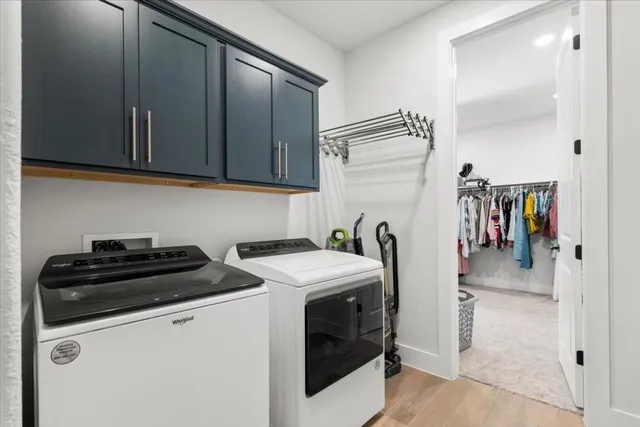 a utility room with sink dryer and washer