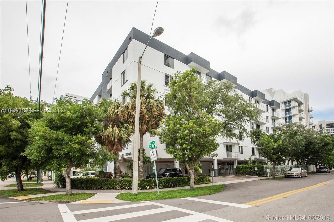 a view of a city street with tall buildings