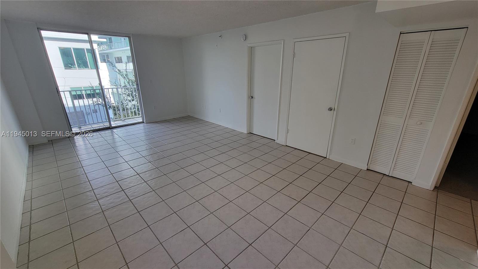 126 Southwest 17th Road, Unit 507 Miami, FL 33129 - Photo 5 of 13 an empty room with windows