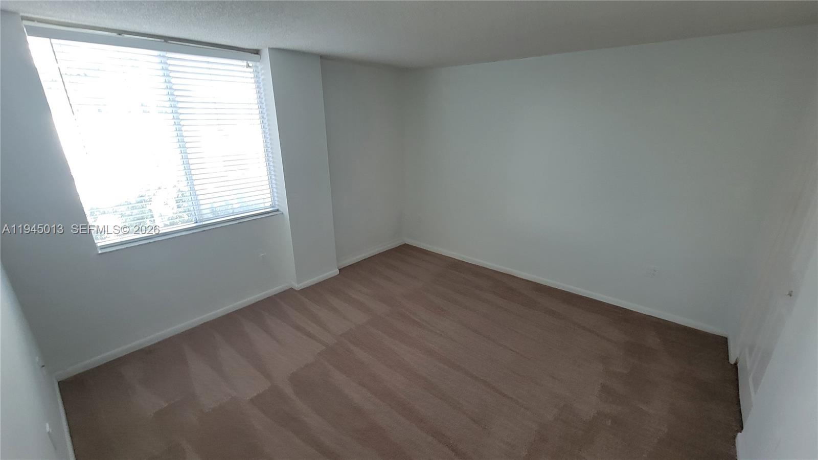 126 Southwest 17th Road, Unit 507 Miami, FL 33129 - Photo 10 of 13 an empty room with a window
