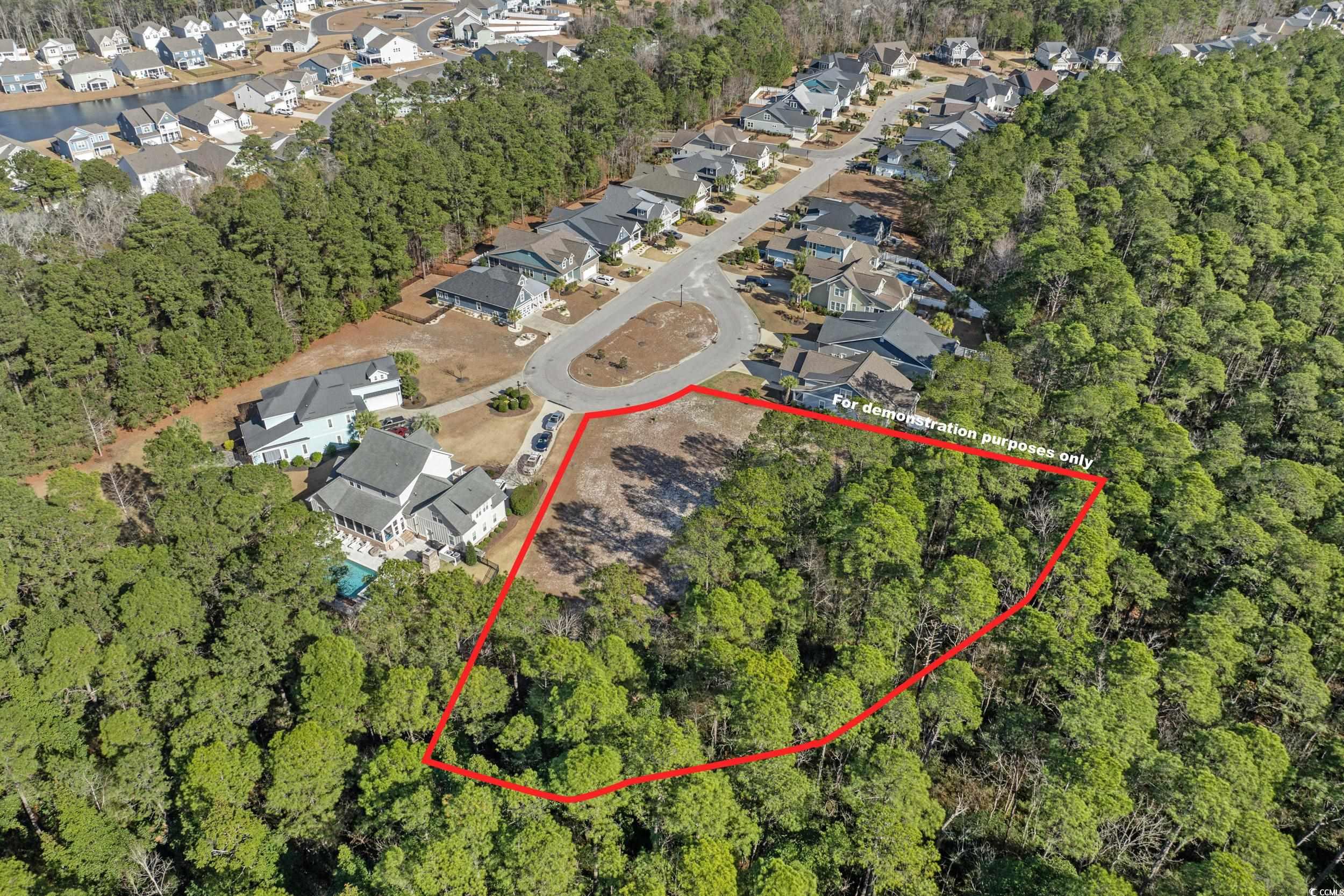 2908 Moss Bridge Lane Myrtle Beach, SC 29579 - Photo 15 of 35 Aerial view of residential area with property parcel outlined and a tree filled landscape. Boundary lines are for demonstration purposes only and should be verified