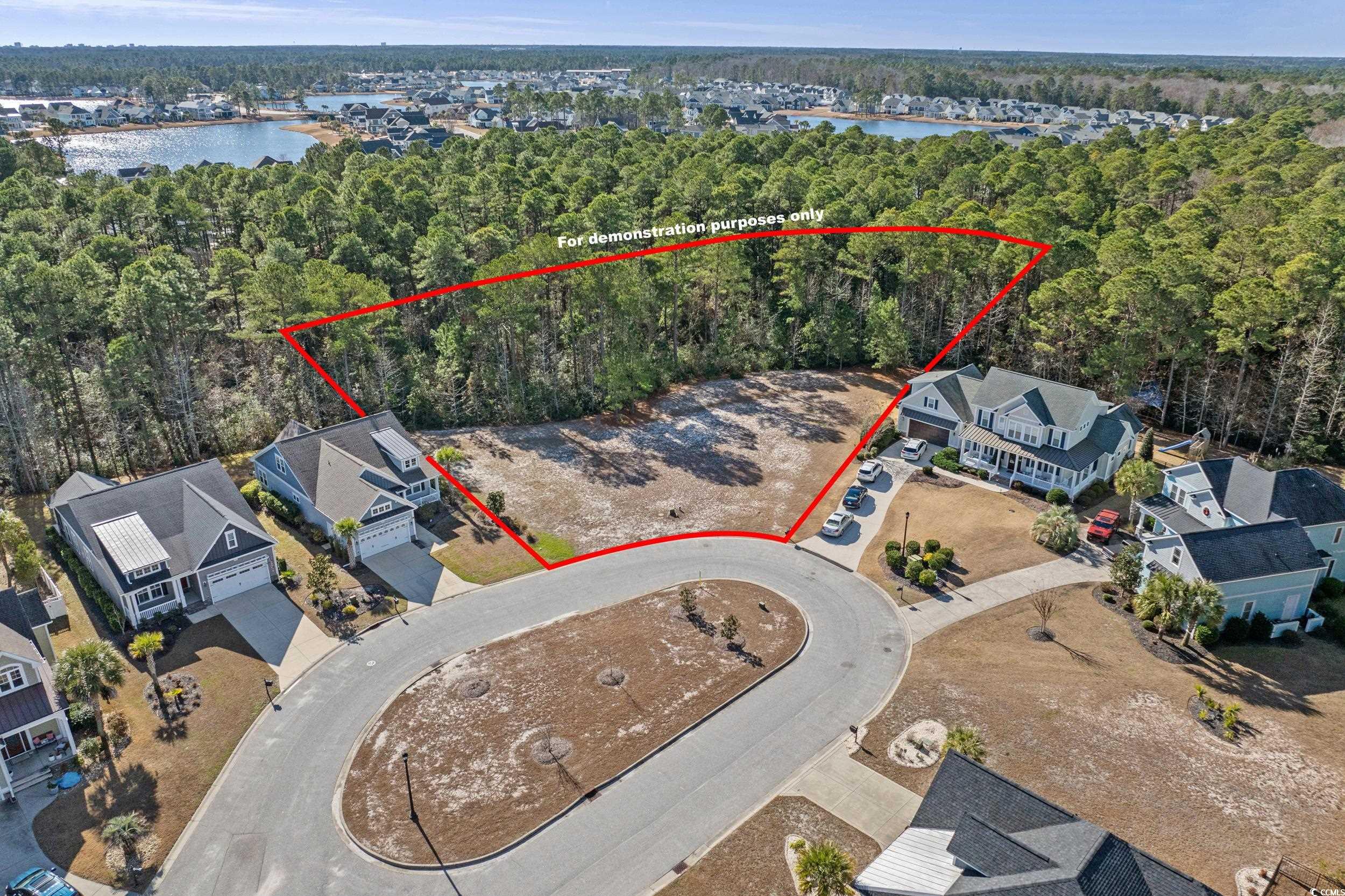 2908 Moss Bridge Lane Myrtle Beach, SC 29579 - Photo 7 of 35 Aerial view of residential area with a nearby body of water and property boundaries highlighted. Boundary lines are for demonstration purposes only and should be verified