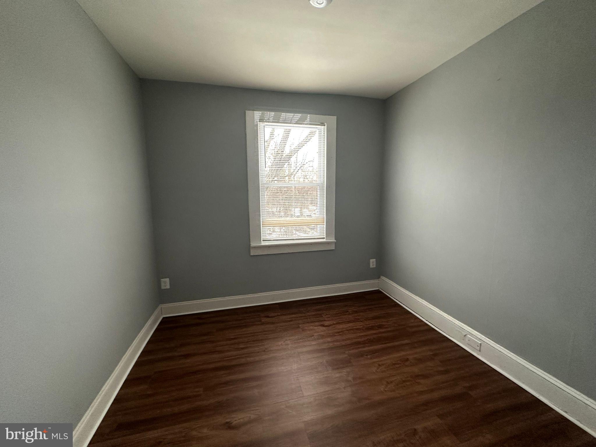 2806 Violet Avenue Baltimore, MD 21215 - Photo 4 of 10 wooden floor in an empty room with a window