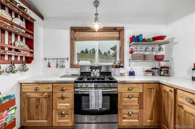 a kitchen with stainless steel appliances granite countertop a stove and a sink