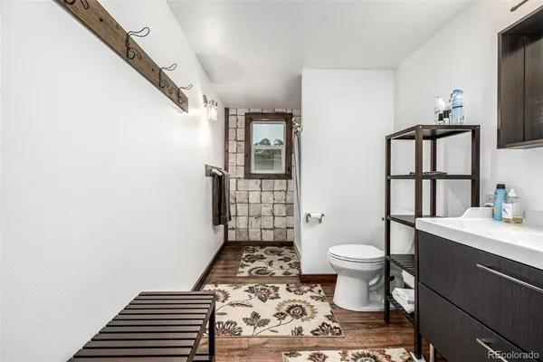 a bathroom with a sink toilet and shower