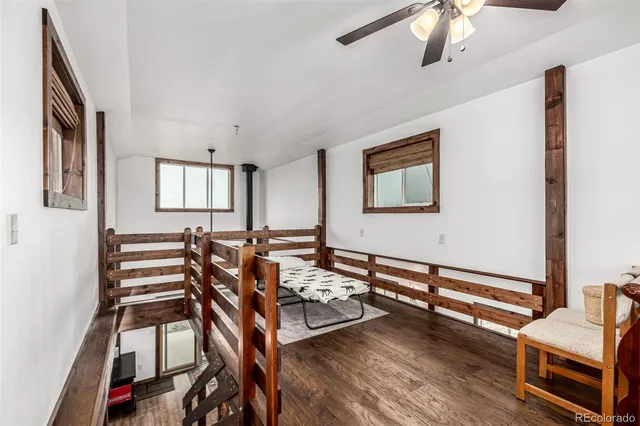 a bedroom with furniture and wooden floor