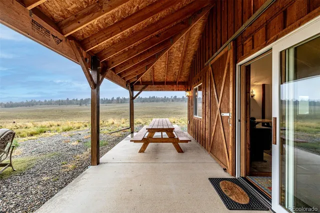 a view of a balcony with floor to ceiling windows with wooden floor