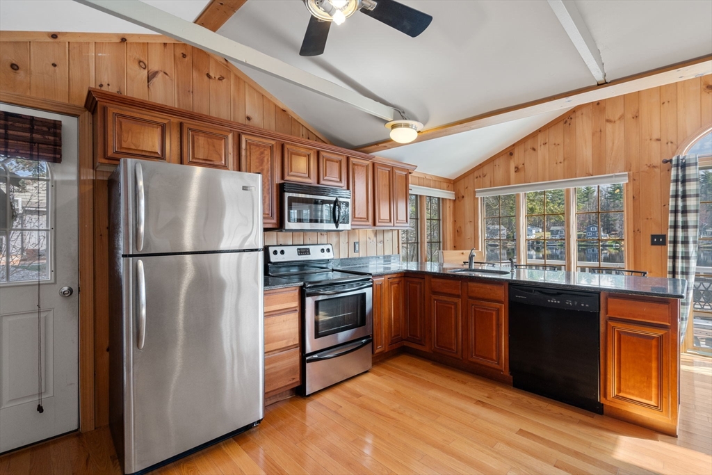 33 Pine Tree Drive Holland, MA 01521 - Photo 6 of 30 a kitchen with stainless steel appliances granite countertop a refrigerator a oven a sink with wooden floors and cabinets