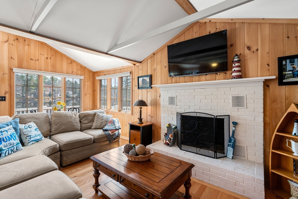 33 Pine Tree Drive Holland, MA 01521 - Photo 9 of 30 a living room with furniture a flat screen tv and a fireplace
