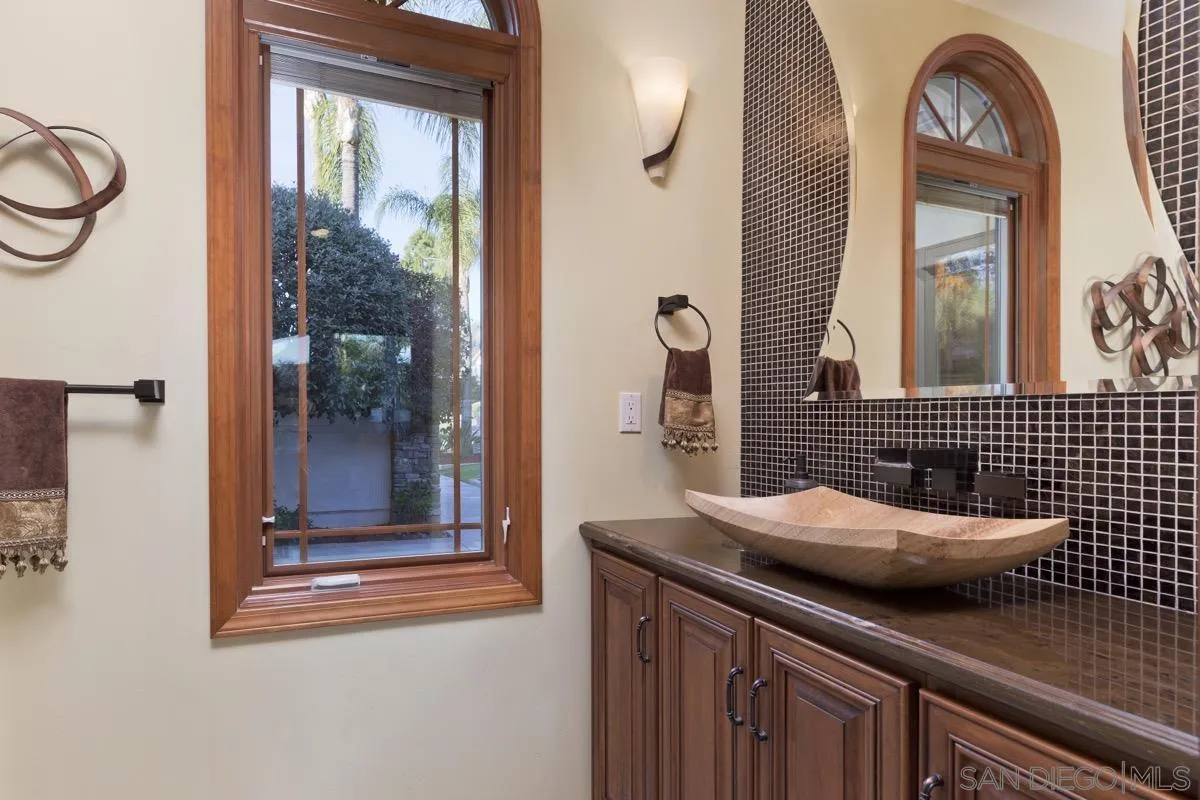 14401 Sandhill Road Poway, CA 92064 - Photo 13 of 75 a bathroom with a sink and a mirror