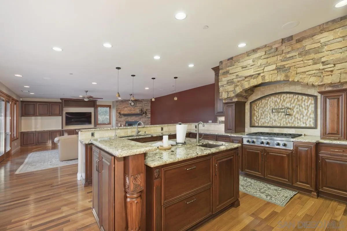 14401 Sandhill Road Poway, CA 92064 - Photo 14 of 75 a kitchen with a sink and cabinets