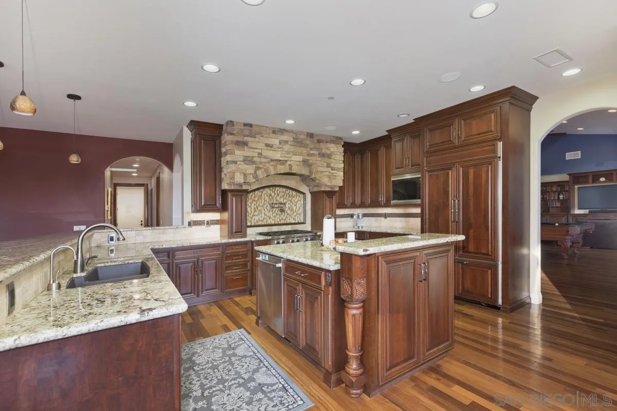 14401 Sandhill Road Poway, CA 92064 - Photo 15 of 75 a kitchen with stainless steel appliances granite countertop a sink stove and refrigerator