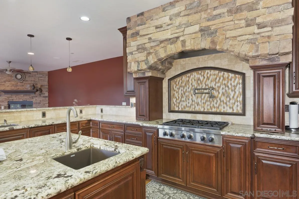 14401 Sandhill Road Poway, CA 92064 - Photo 16 of 75 a kitchen with stainless steel appliances granite countertop a sink and a stove