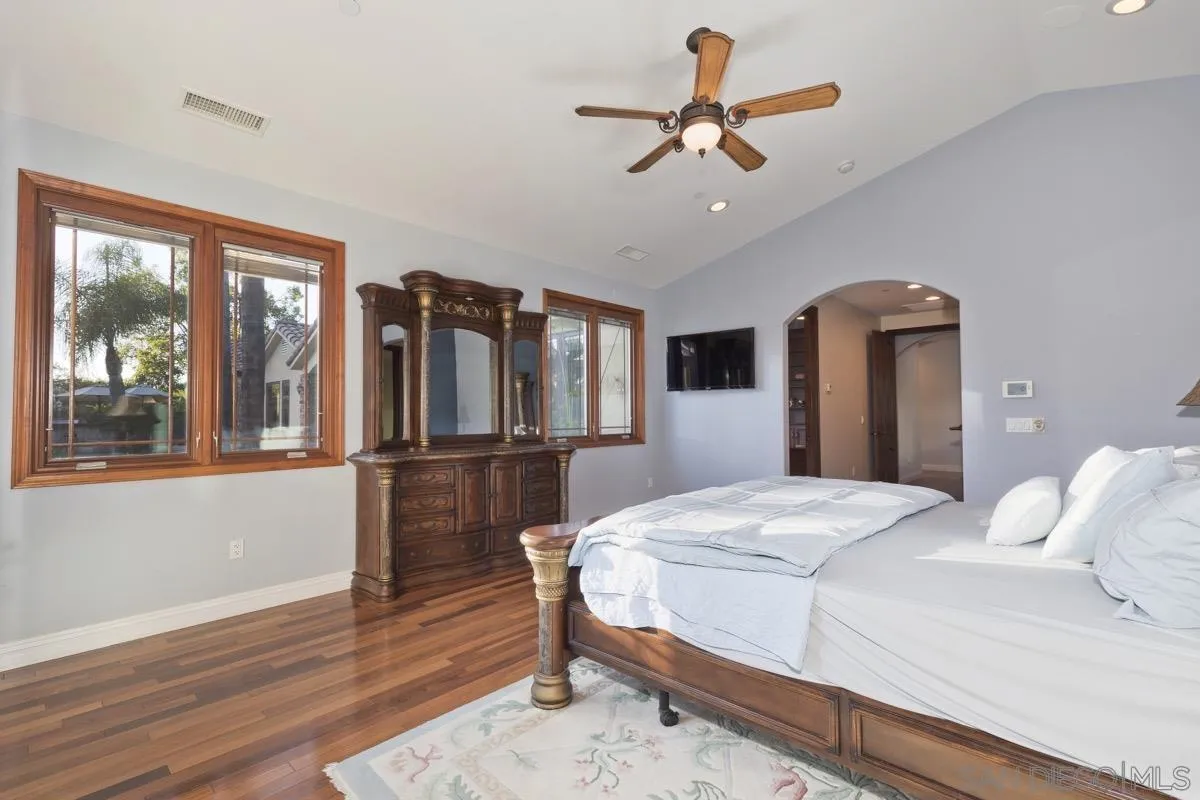 14401 Sandhill Road Poway, CA 92064 - Photo 25 of 75 a bedroom with a large bed chandelier and a window