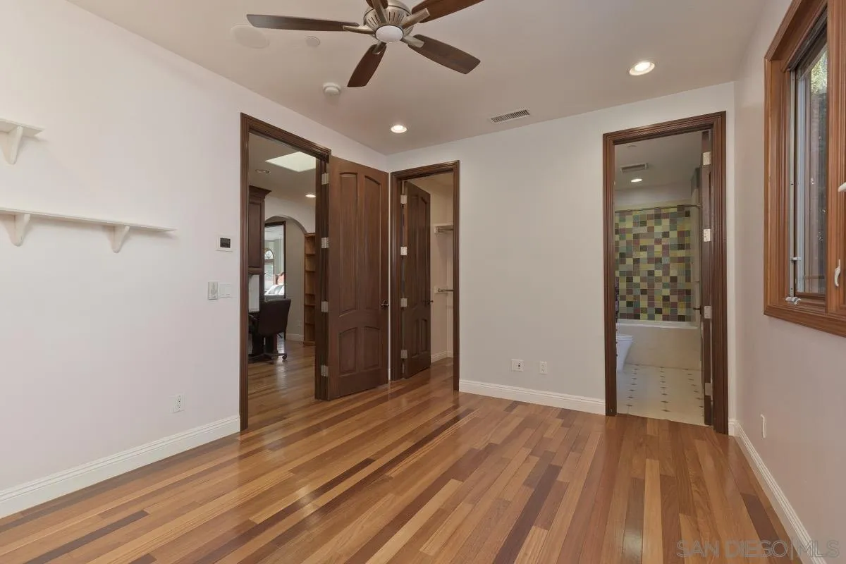 14401 Sandhill Road Poway, CA 92064 - Photo 33 of 75 a view of an empty room with wooden floor and a ceiling fan