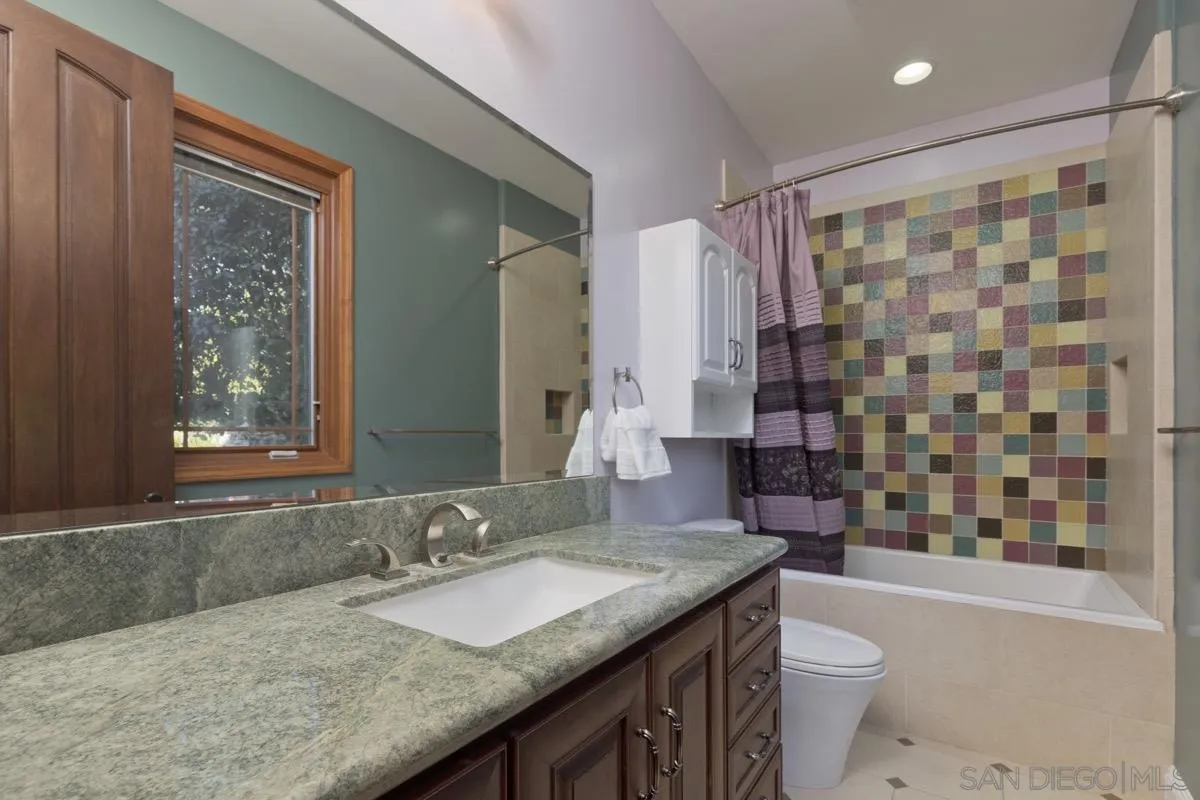 14401 Sandhill Road Poway, CA 92064 - Photo 34 of 75 a bathroom with a granite countertop sink toilet and shower