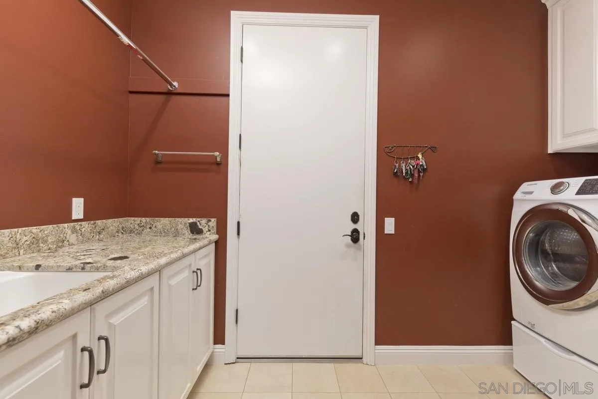 14401 Sandhill Road Poway, CA 92064 - Photo 36 of 75 a bathroom with a sink and a washer dryer
