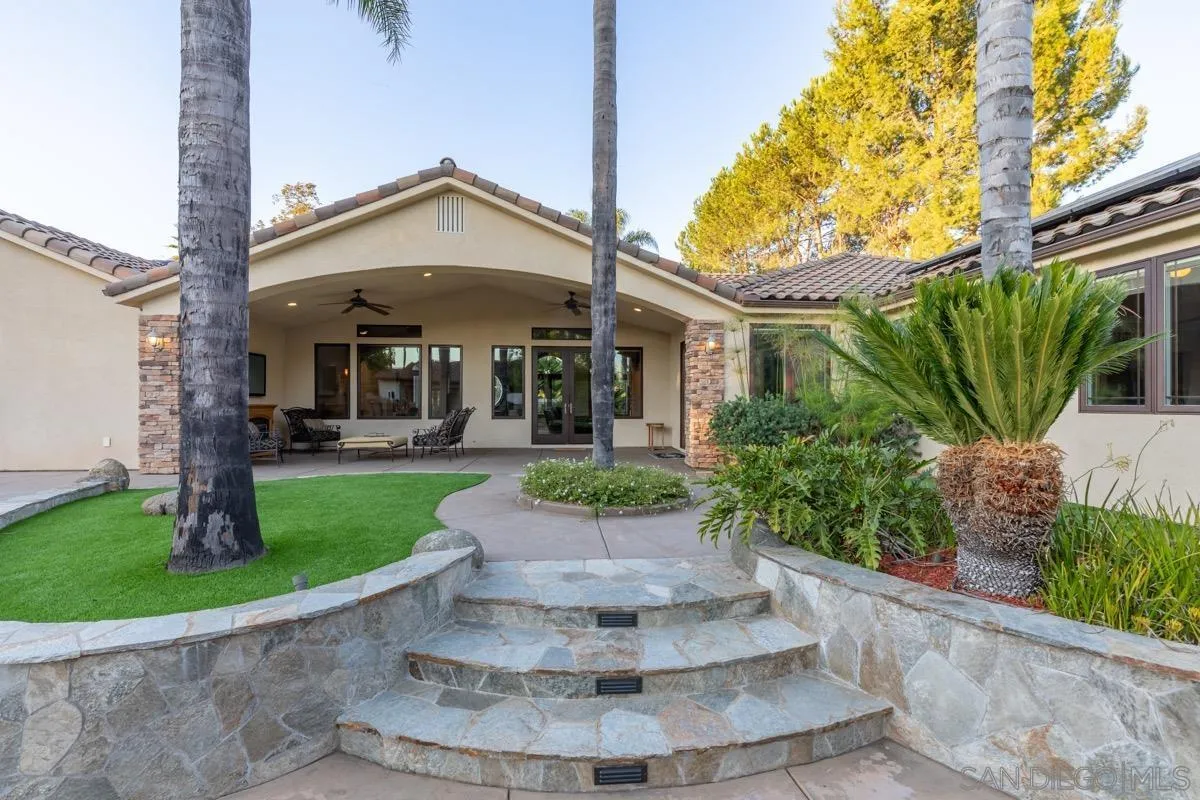 14401 Sandhill Road Poway, CA 92064 - Photo 51 of 75 a view of a white house with a big yard and potted plants