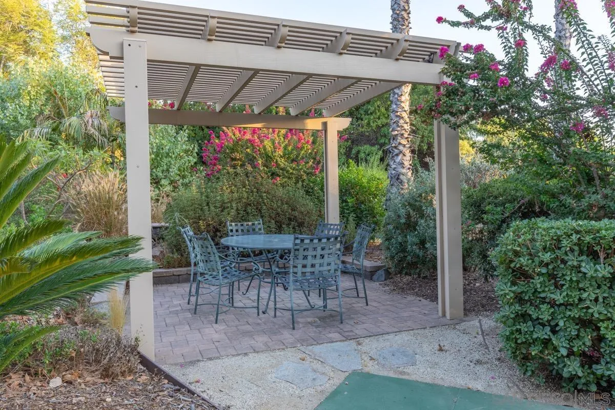 14401 Sandhill Road Poway, CA 92064 - Photo 61 of 75 a view of a patio with a table chairs and a backyard