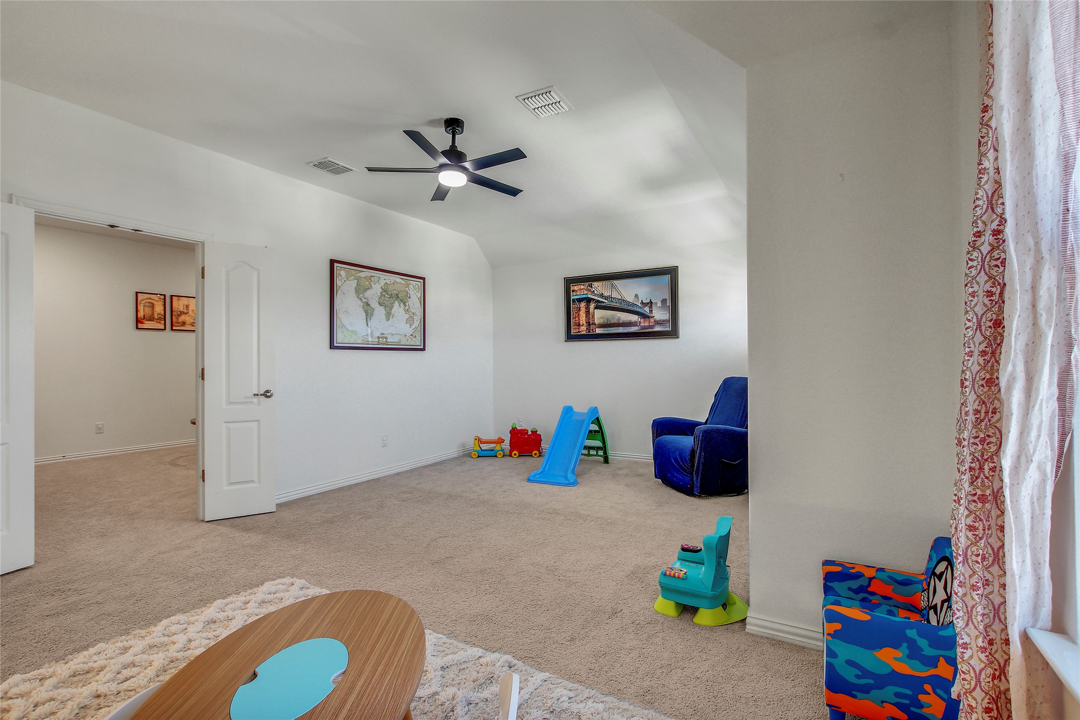 104 Millbend Road Georgetown, TX 78633 - Photo 32 of 40 A playroom featuring a practical ceiling fan, soft carpeting, and warm natural light.
