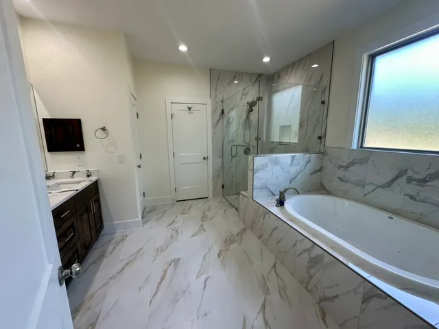 a spacious bathroom with a double vanity sink and a mirror