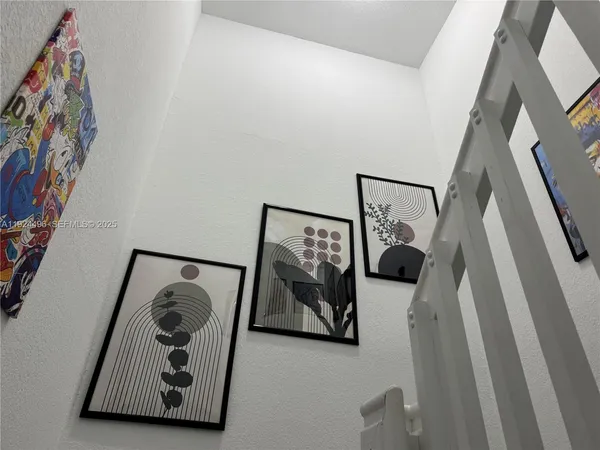 a living room with furniture and a wall painting