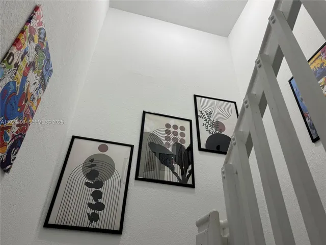 a living room with furniture and a wall painting