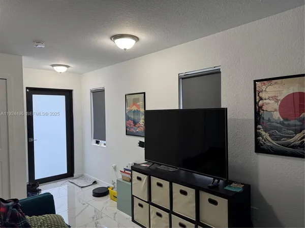 a living room with furniture and flat screen tv