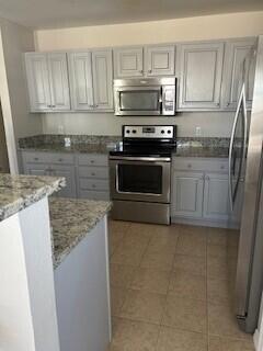14 Marlin Court Santa Rosa Beach, FL 32459 - Photo 3 of 7 a kitchen with granite countertop a refrigerator stove and microwave