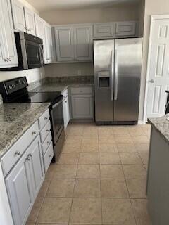 14 Marlin Court Santa Rosa Beach, FL 32459 - Photo 4 of 7 a kitchen with granite countertop a refrigerator a sink a stove a microwave and cabinets