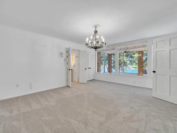 a view of room with window and wooden floor
