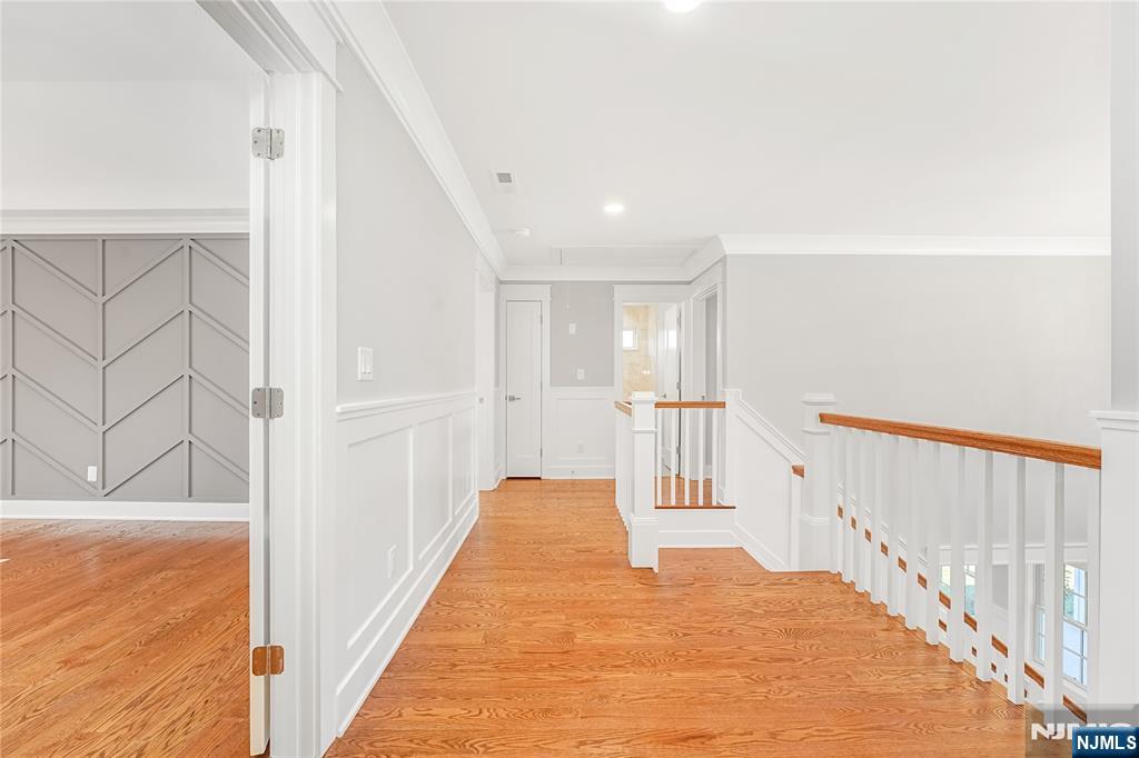 1 Lourdes Court Andover, NJ 07821 - Photo 16 of 40 a view of a hallway with wooden floor and staircase