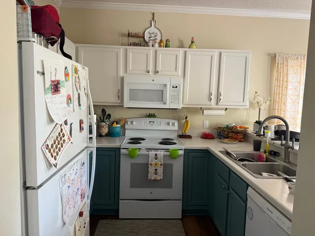 a kitchen with stainless steel appliances granite countertop a sink and a refrigerator