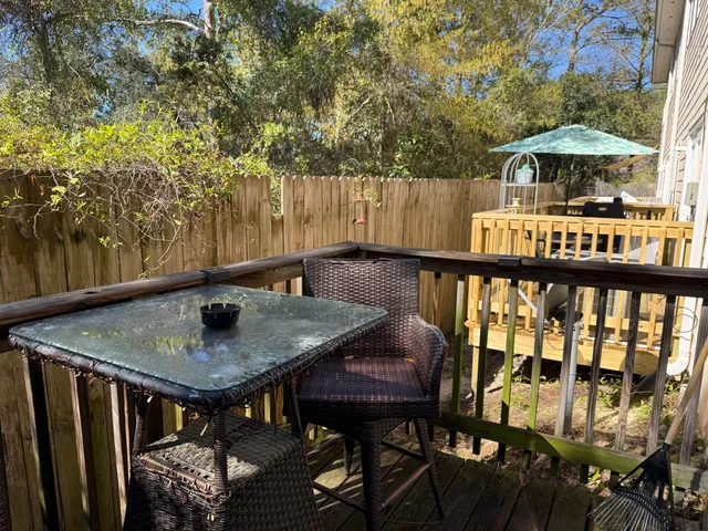 a balcony with table and chairs