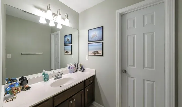 a view of walk in closet with clothes