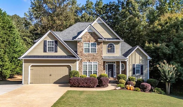 a front view of a house with a yard and garage
